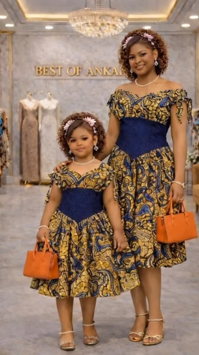 Woman and girl in matching yellow and blue Ankara print dresses with orange handbags.