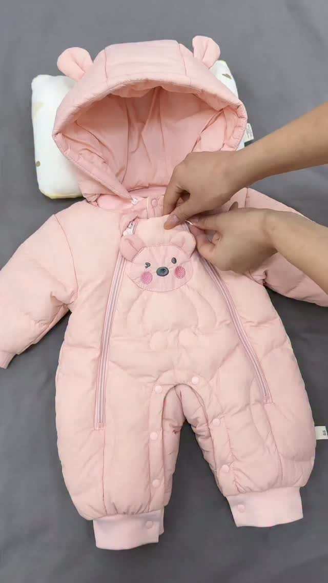 Pink quilted baby snowsuit with bear ears and a bear face on chest.