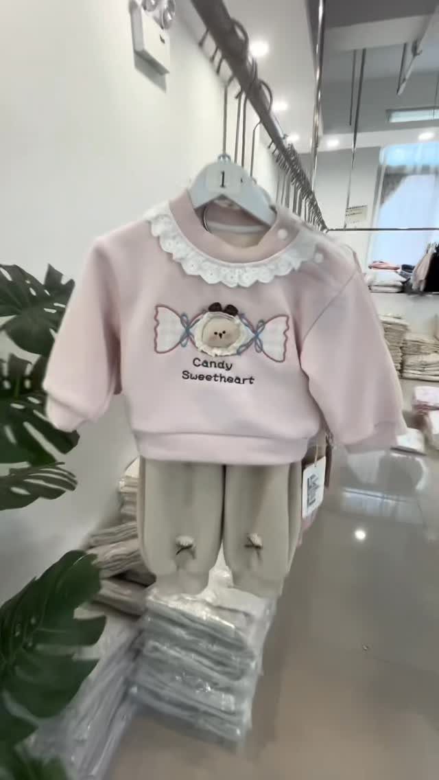 Chinese Infant Clothing: 7 Ideas for Baby Outfits 3 Pink baby outfit with lace collar and beige pants hanging in a shop