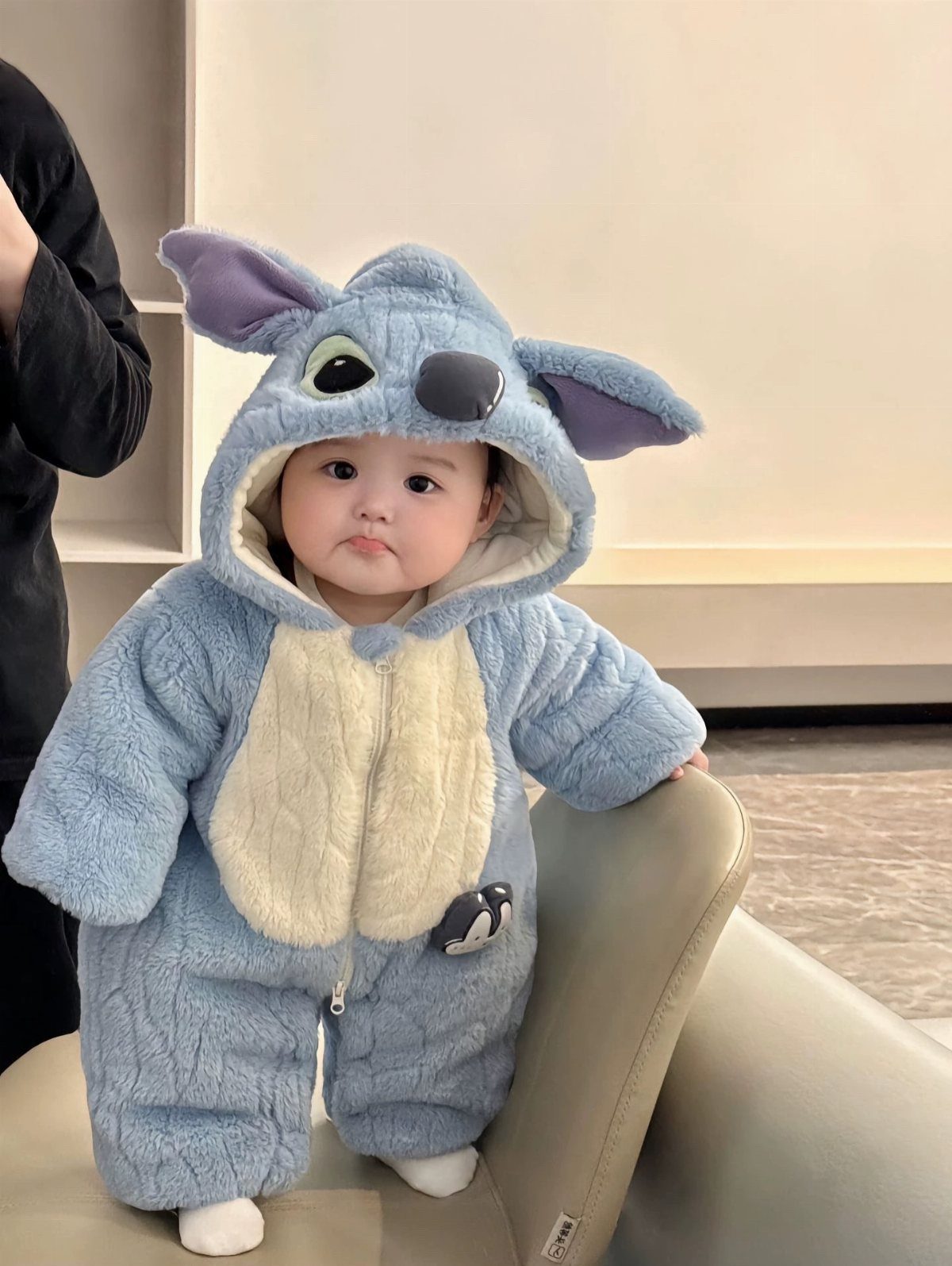 Chinese Infant Clothing: 7 Ideas for Baby Outfits 2 Baby wearing a light blue plush Stitch character hooded romper standing indoors.