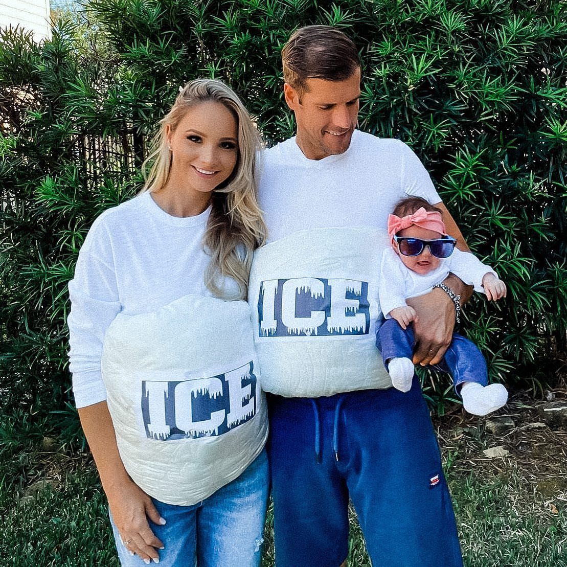Family in matching ice pack costumes with a baby wearing sunglasses outdoors.