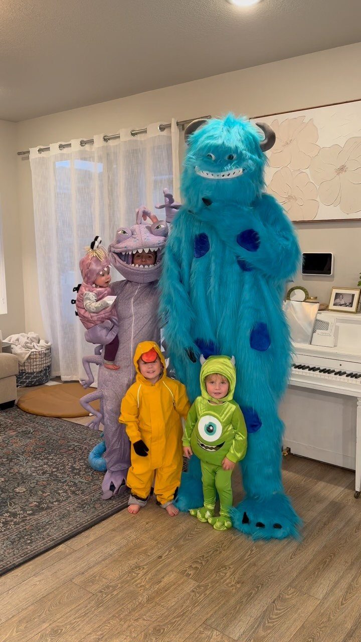 Family in Monsters Inc. costumes including a baby, two children, and two adults.