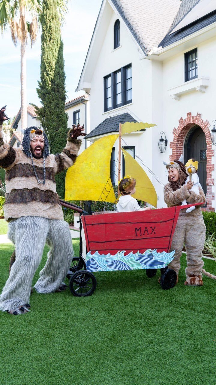 Family in Where the Wild Things Are costumes with a boat-shaped wagon.