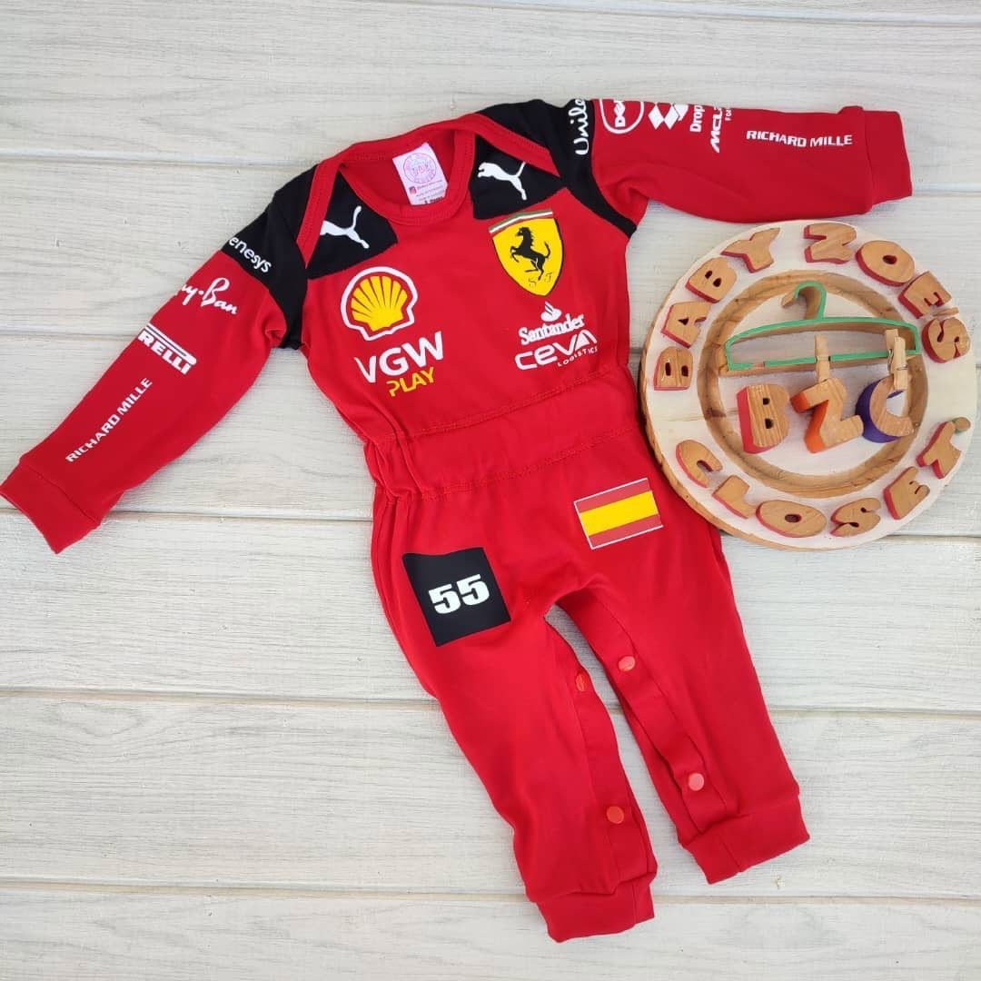 Ferrari Newborn Clothes: 8 Ideas for Red Racing Looks 8 Red Ferrari baby racing jumpsuit with sponsor logos on a white wooden background.