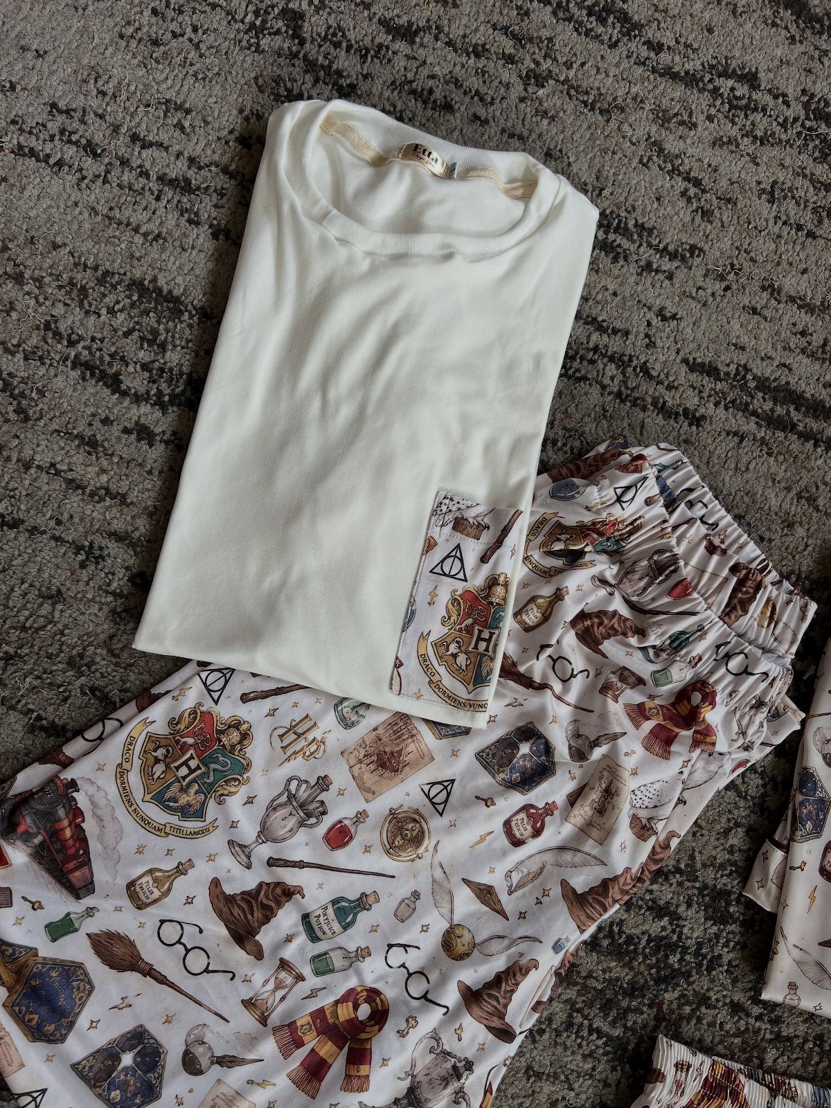 Harry Potter Baby Clothes: 5 Ideas for Little Wizards 5 White baby t-shirt and matching patterned pants with Harry Potter themed illustrations.