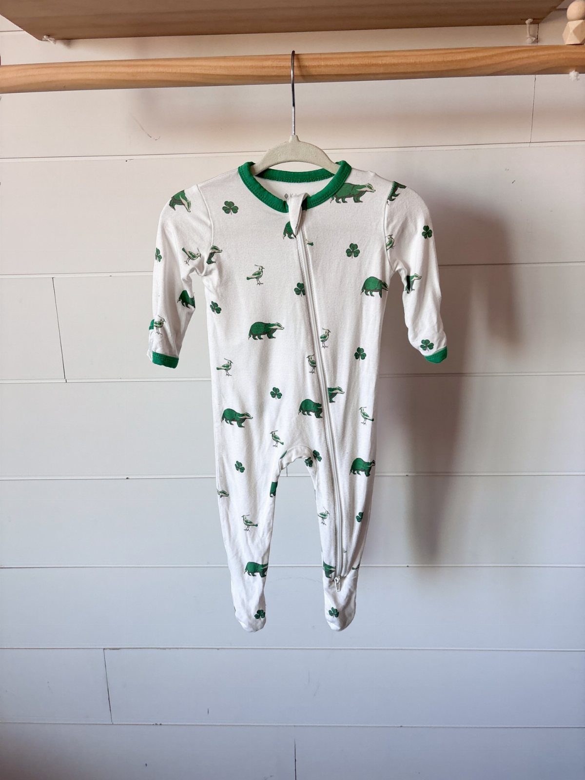 Infant St Patty's Day Clothing: 7 Ideas for Baby 2 White infant footless sleeper with green alligators and shamrocks hanging on a rod.