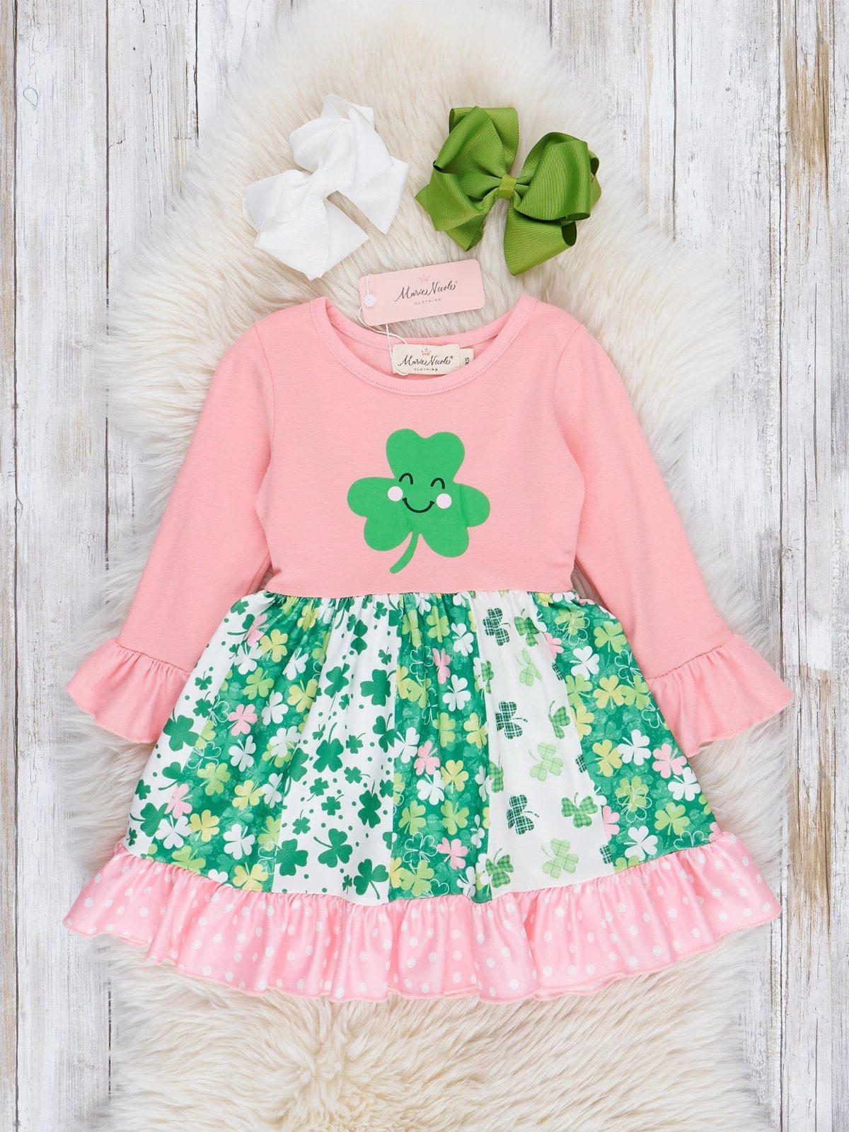 Infant St Patty's Day Clothing: 7 Ideas for Baby 6 Pink baby dress with shamrock print skirt and two hair bows on fur.