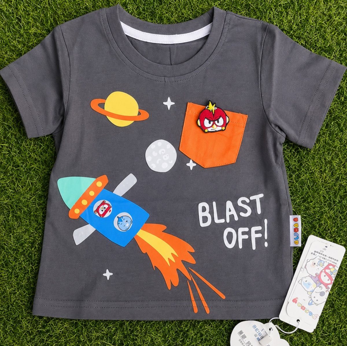Grey children's t-shirt with space rocket and planets on green grass