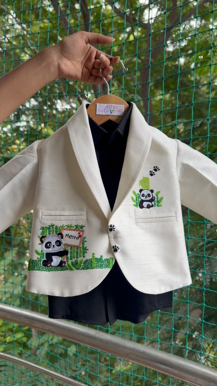 White child's blazer with embroidered panda bears and bamboo on a hanger
